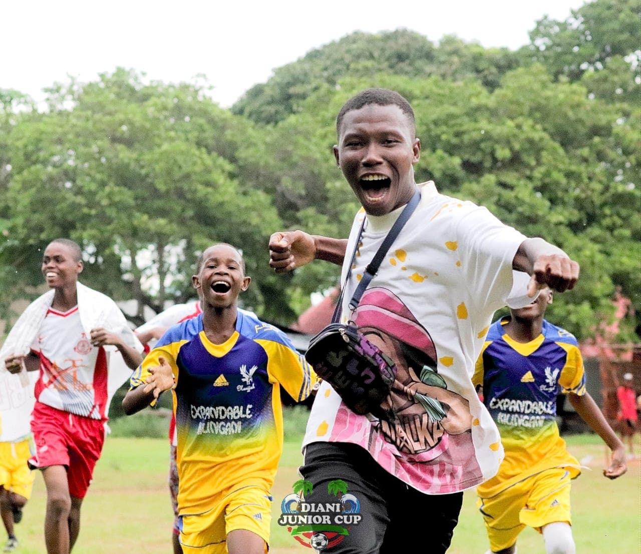 DJC players and a coach celebrating together after a match.