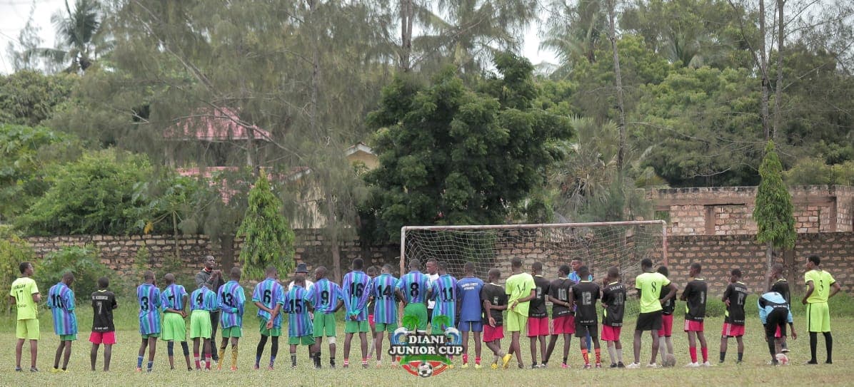 DJC teams assembled together beside the football pitch.